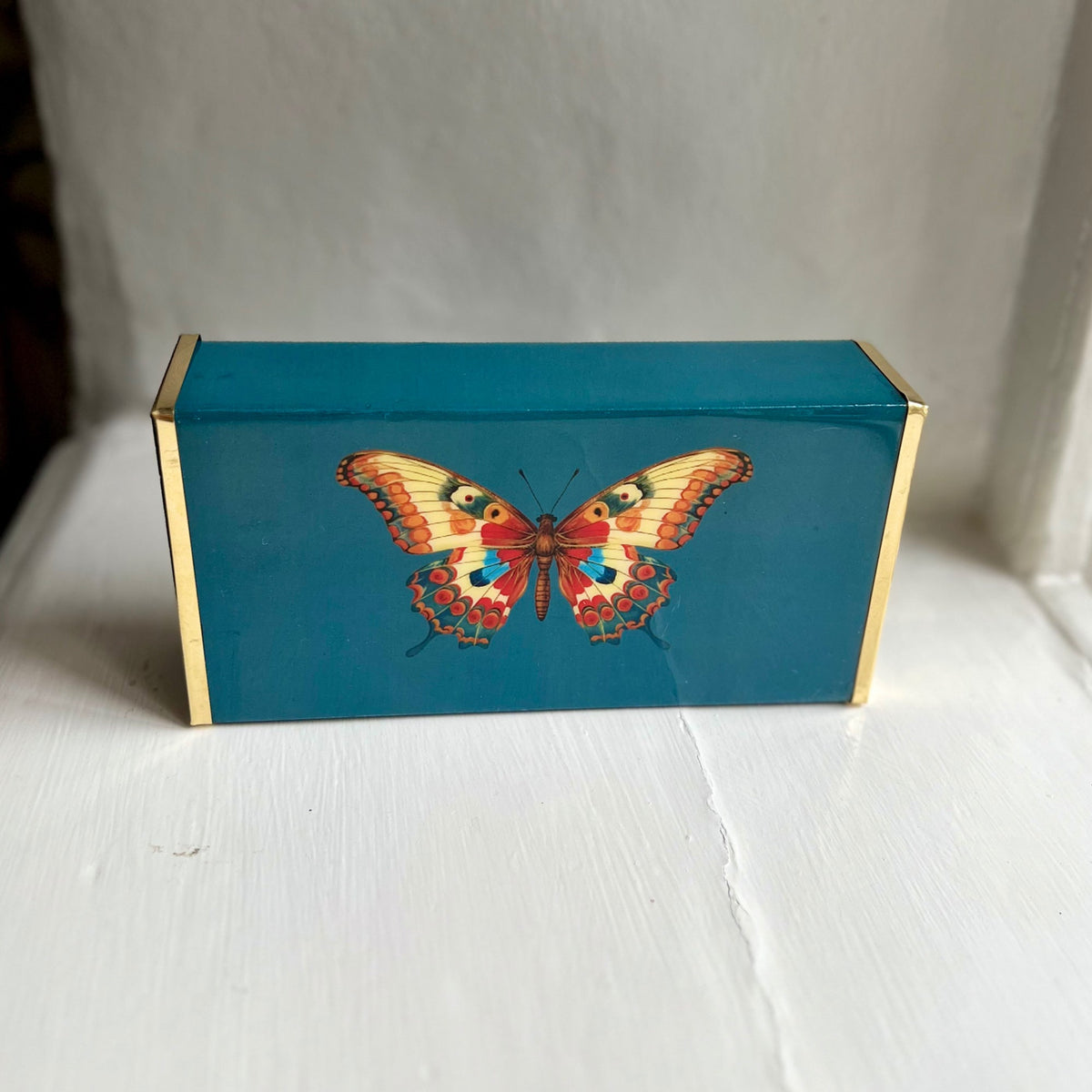 Butterfly oversized matchbox in teal enamel and brass, front view