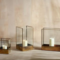 Sampara storm lanterns in glass and antique brass with pillar candles