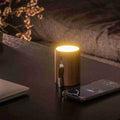 Drum light Bluetooth speaker glowing on a desk beside a phone