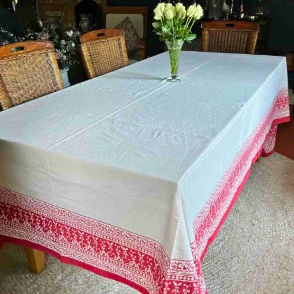 Ruby Garland block printed tablecloth on a dining table with wicker chairs