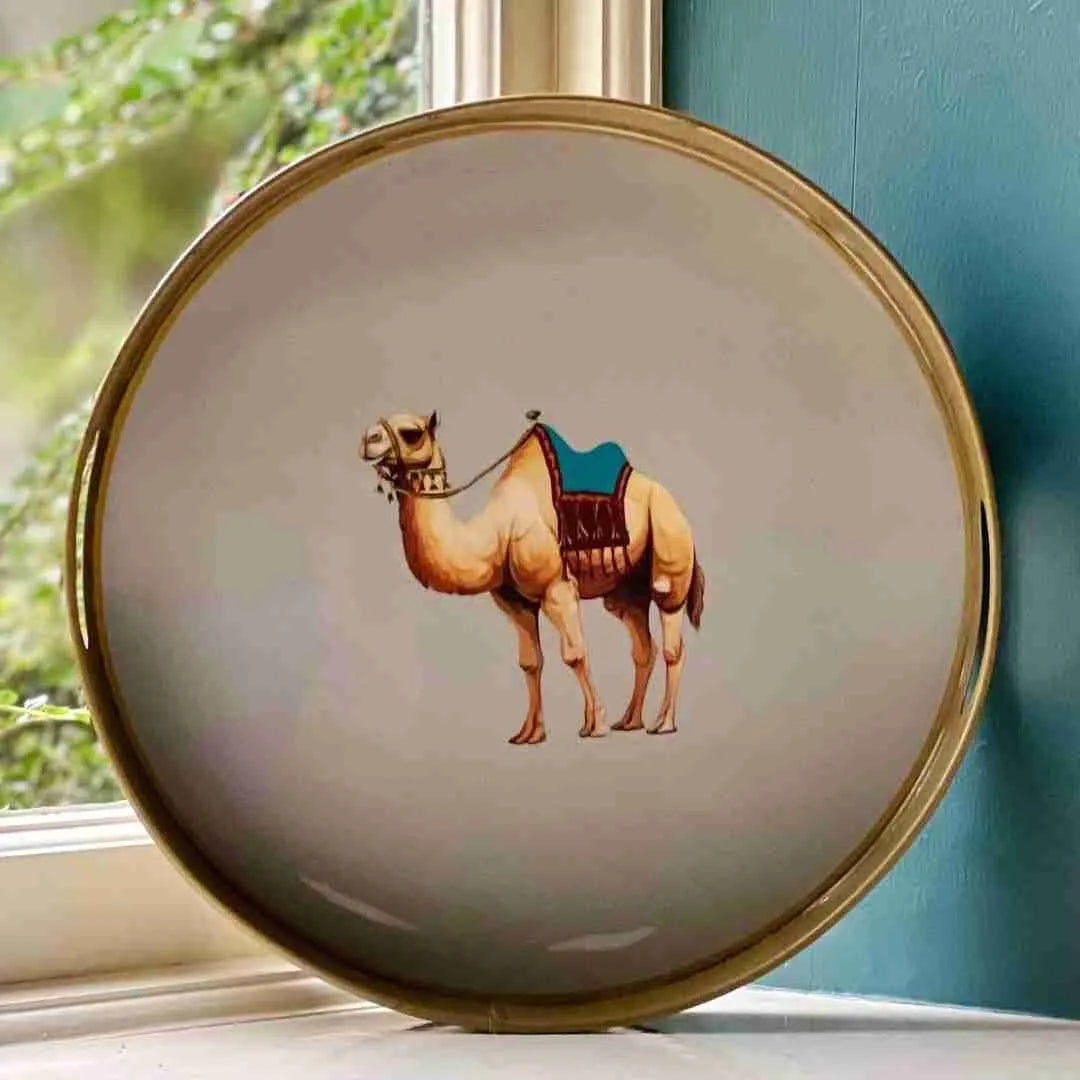 Round decorative tray with a camel illustration and a gold rim