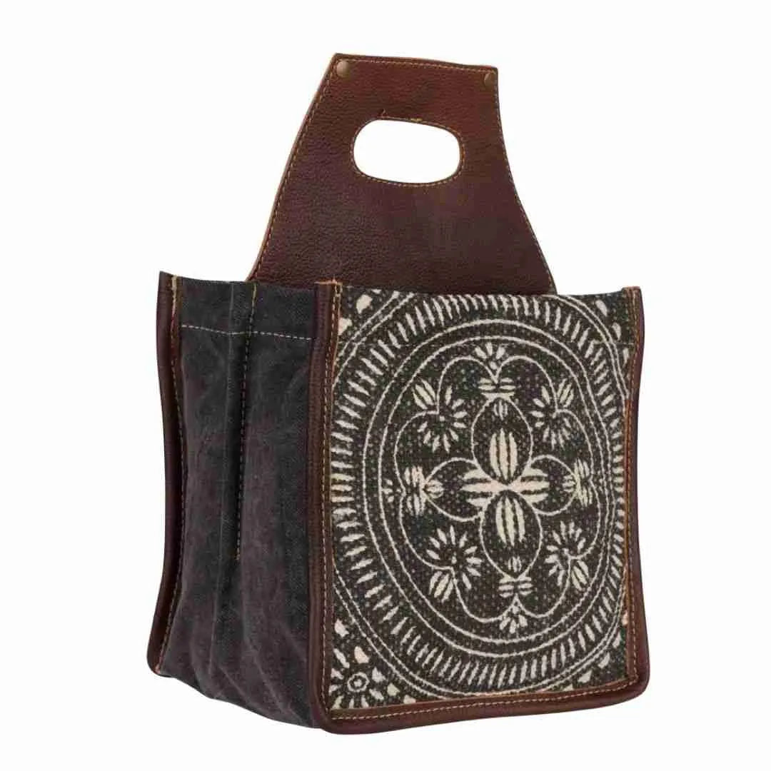 Tapestry beer caddy side view showing the leather handle and canvas sides