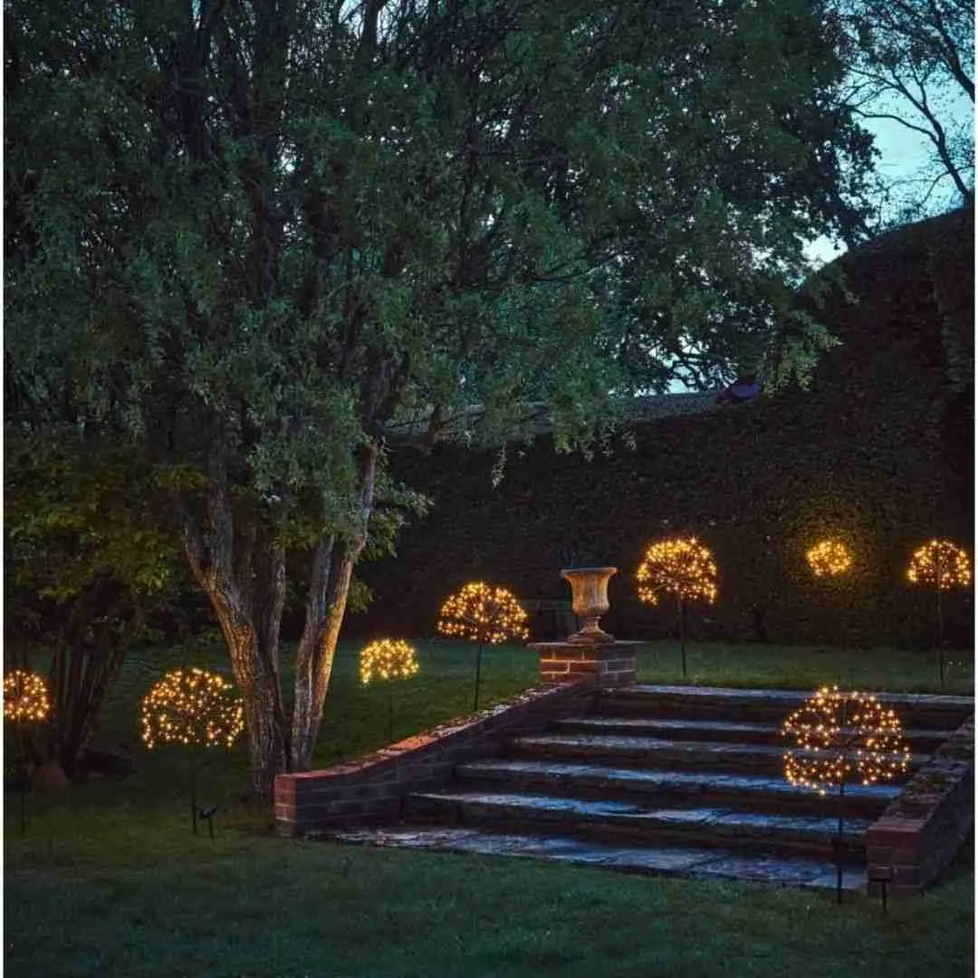 Starburst solar lights along garden steps at dusk