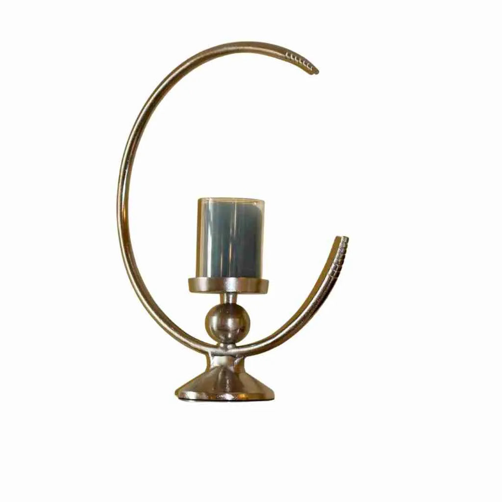 Half moon pillar candle holder in polished metal on a white background