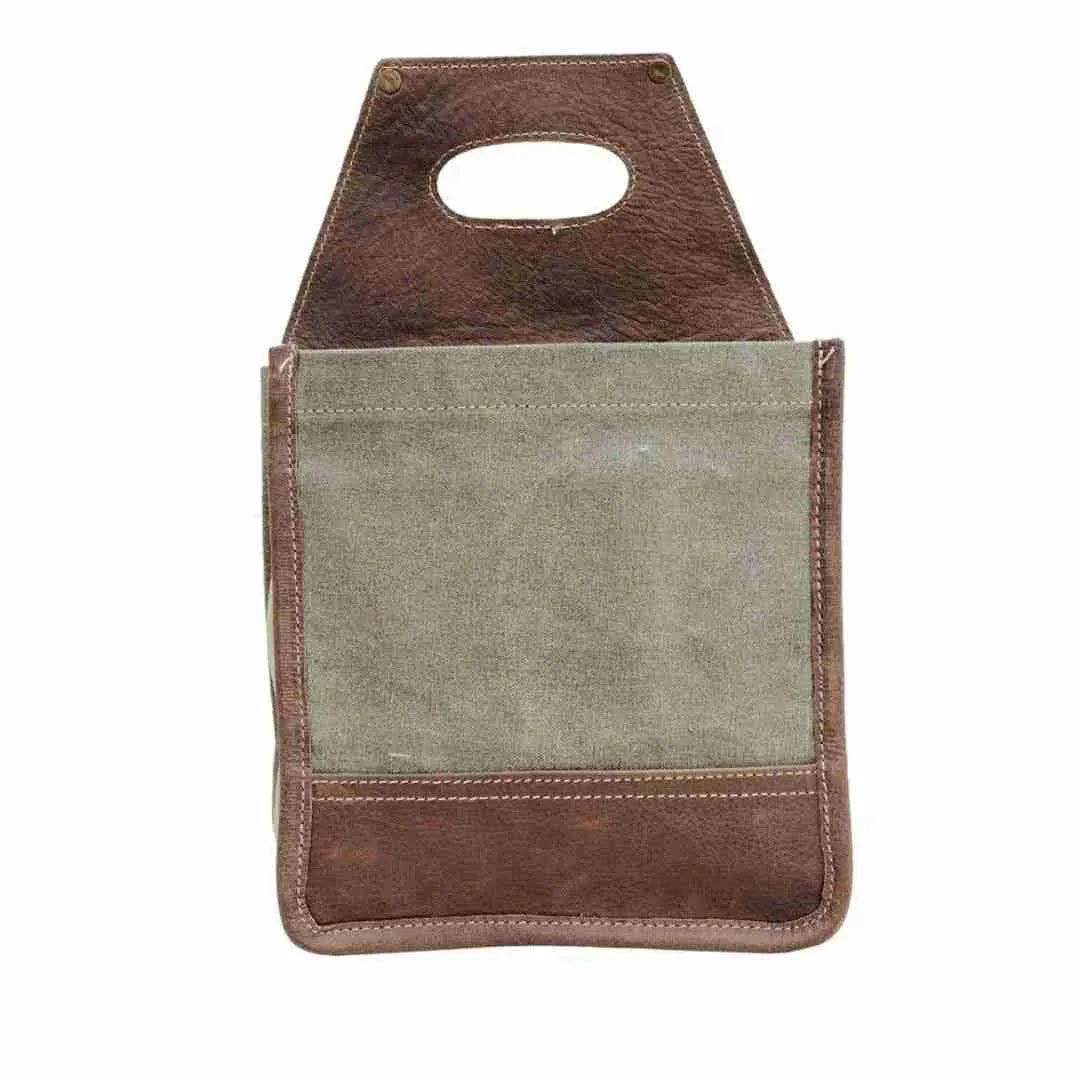 Back of the olive canvas beer caddy with a leather base