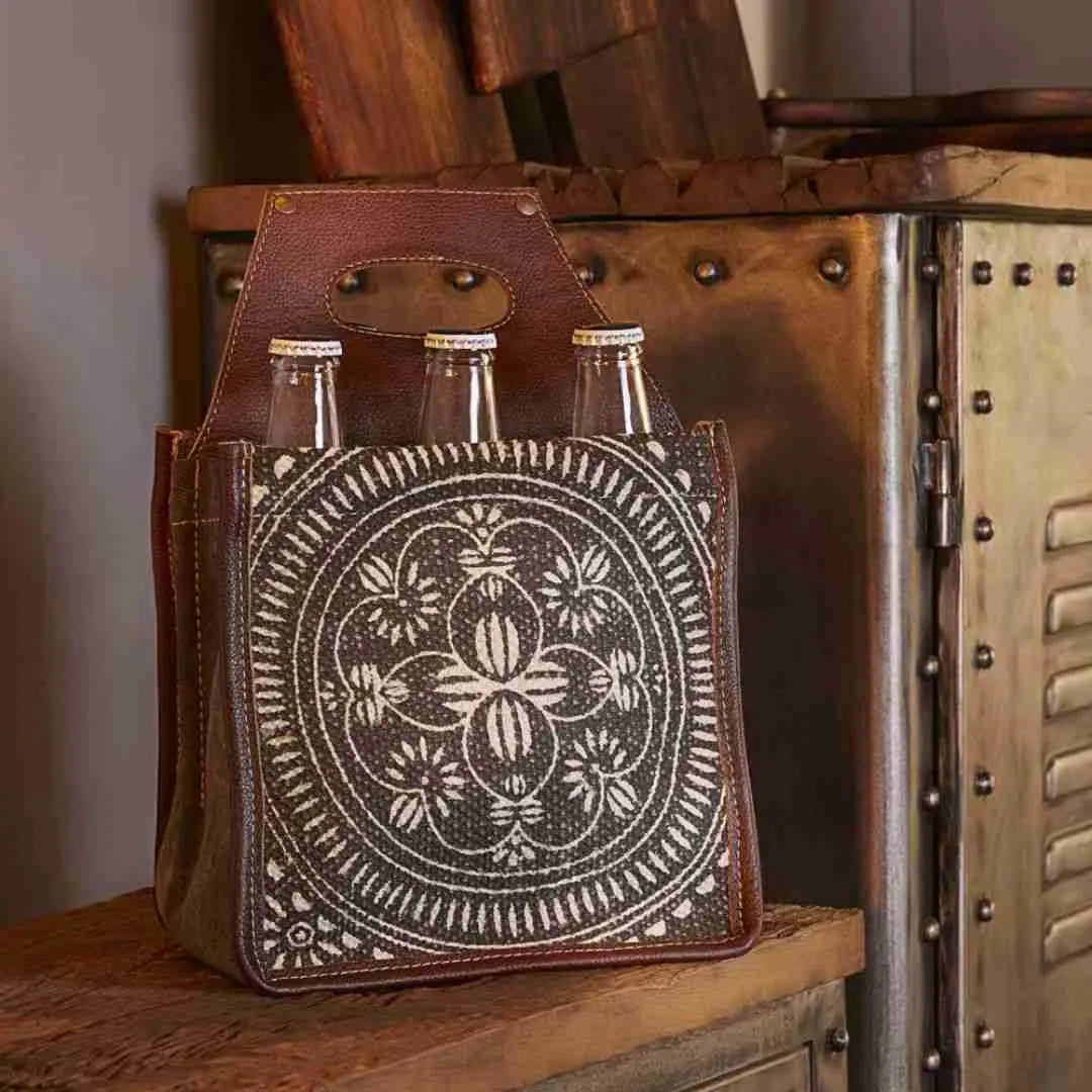 Tapestry beer caddy with a leather handle, holding six bottles