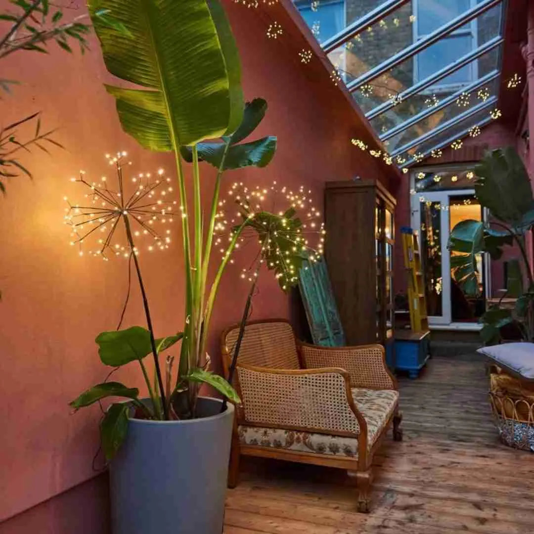Dandelion starburst light in a plant pot on a conservatory terrace