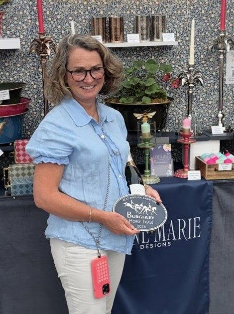 Anne-Marie on her stand holding the Best Pavilion Exhibitor plaque, Burghley Horse Trials 2026