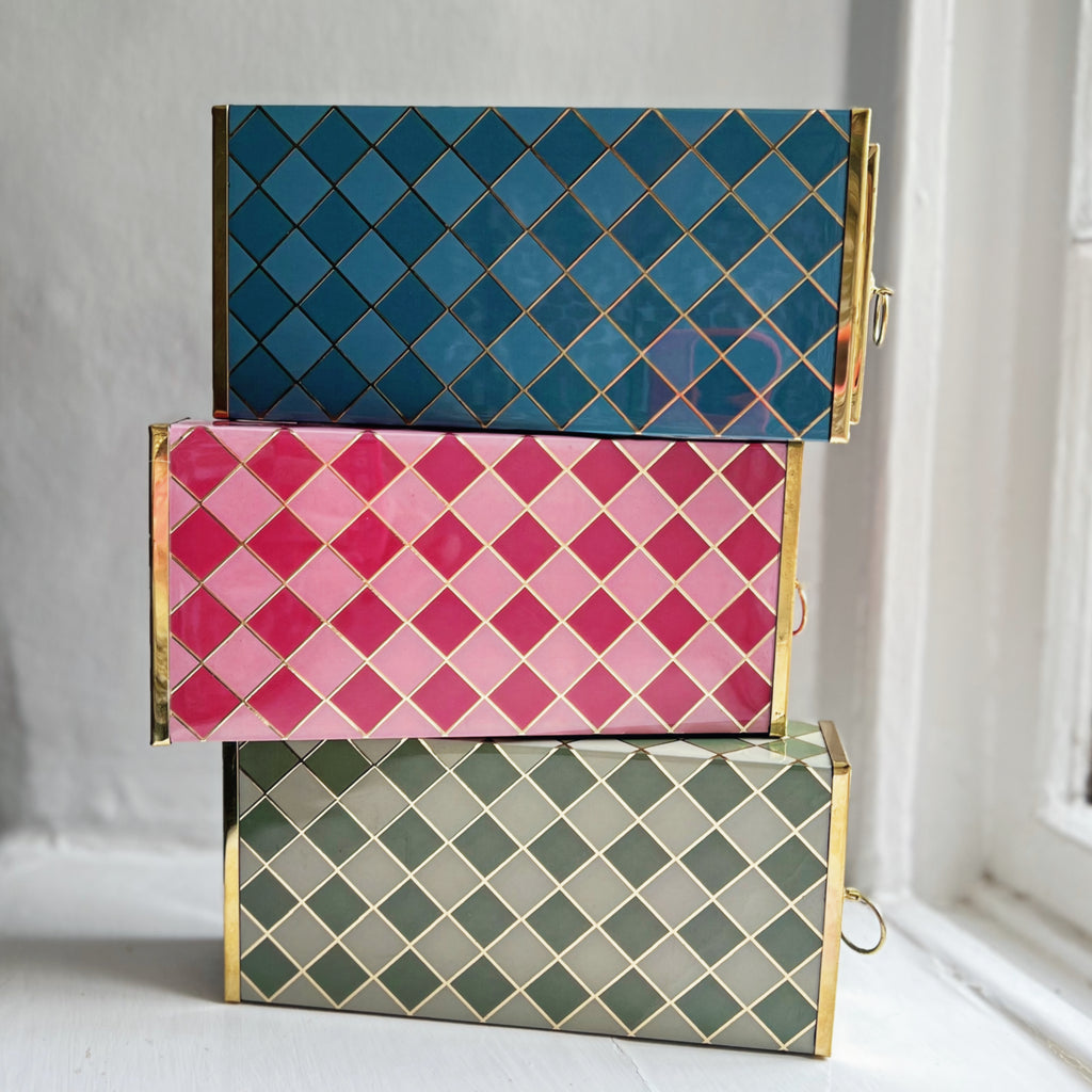 Harlequin matchboxes stacked in Denim Blue, Raspberry Pink and Sage Green