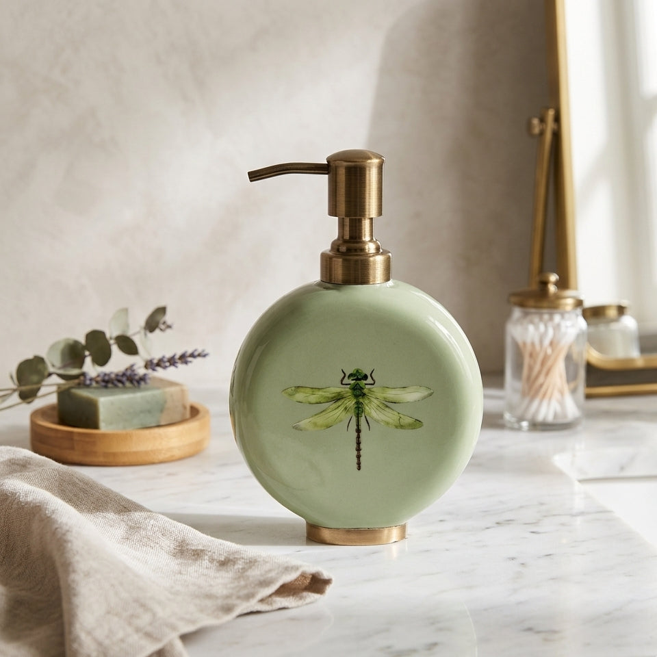 Dragonfly enamel and brass soap dispenser in sage green on a shelf