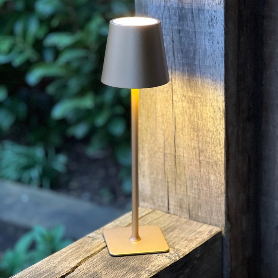 Gold LED cordless lamp switched on outdoors