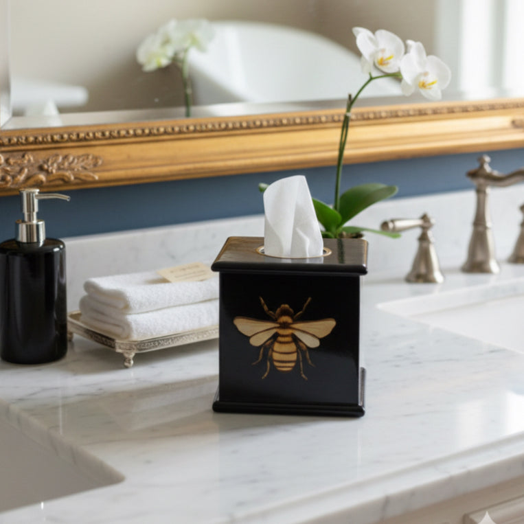 Honeybee square tissue box in dark green enamel and brass on a bathroom vanity
