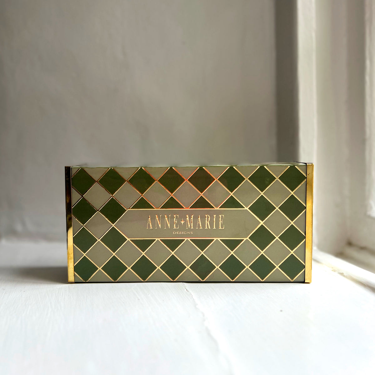 Harlequin oversized matchbox in Sage Green showing the Anne-Marie Designs label
