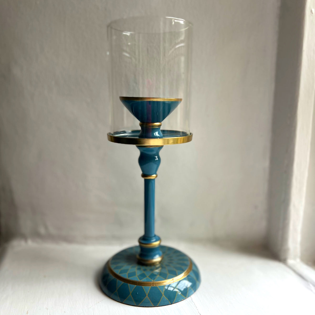 Harlequin hand-enamelled brass hurricane candle holder in Denim Blue with a glass sleeve