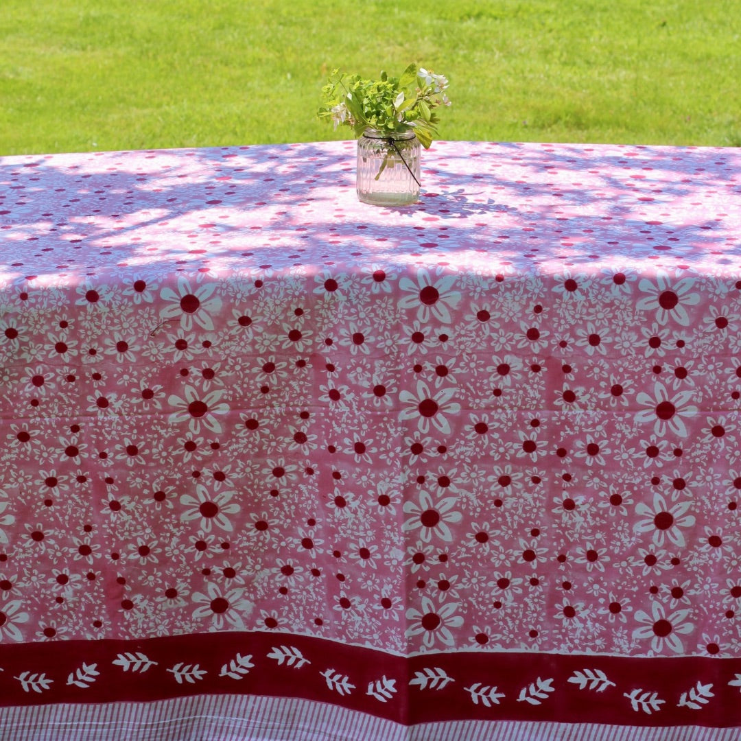 Pink daisies rectangular tablecloth on a garden table