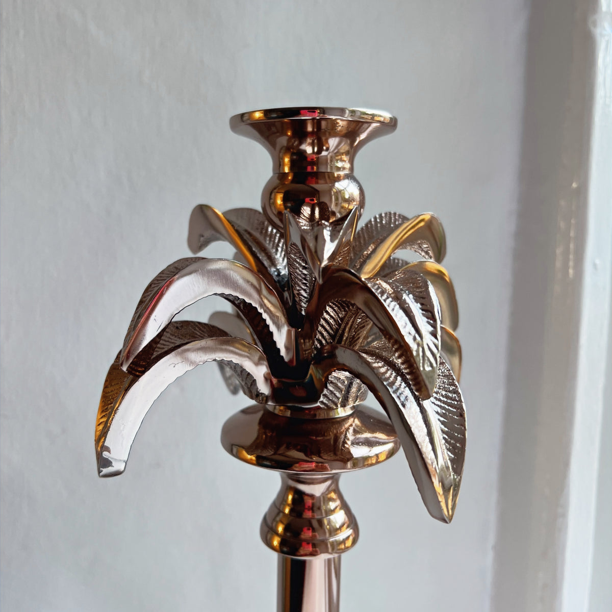Close-up of the textured palm fronds on the small candlestick