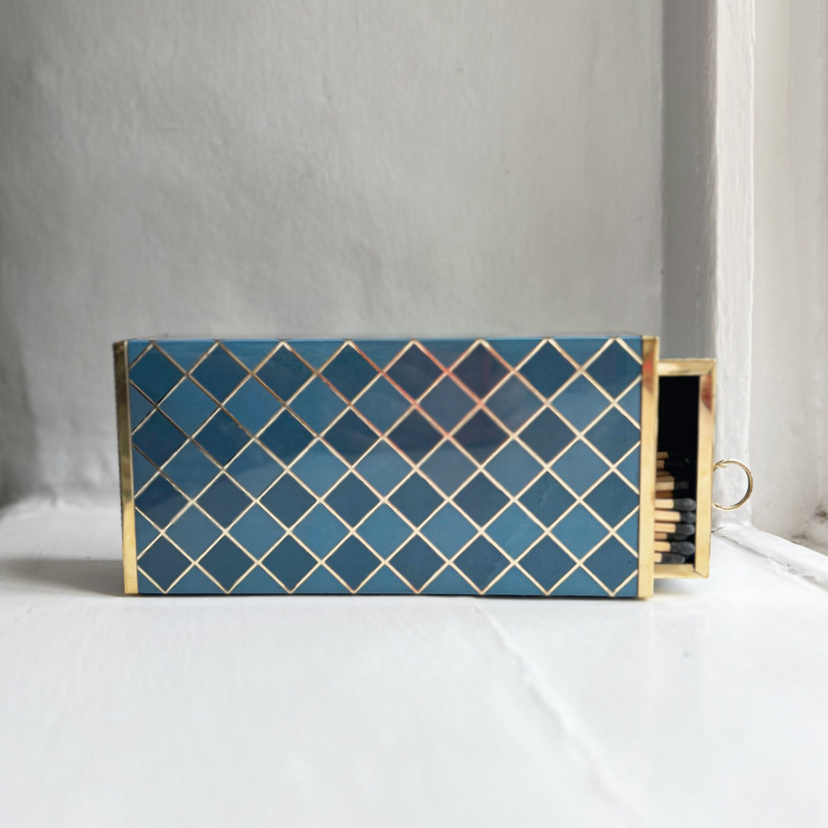 Harlequin oversized matchbox in Denim Blue with the drawer slightly open