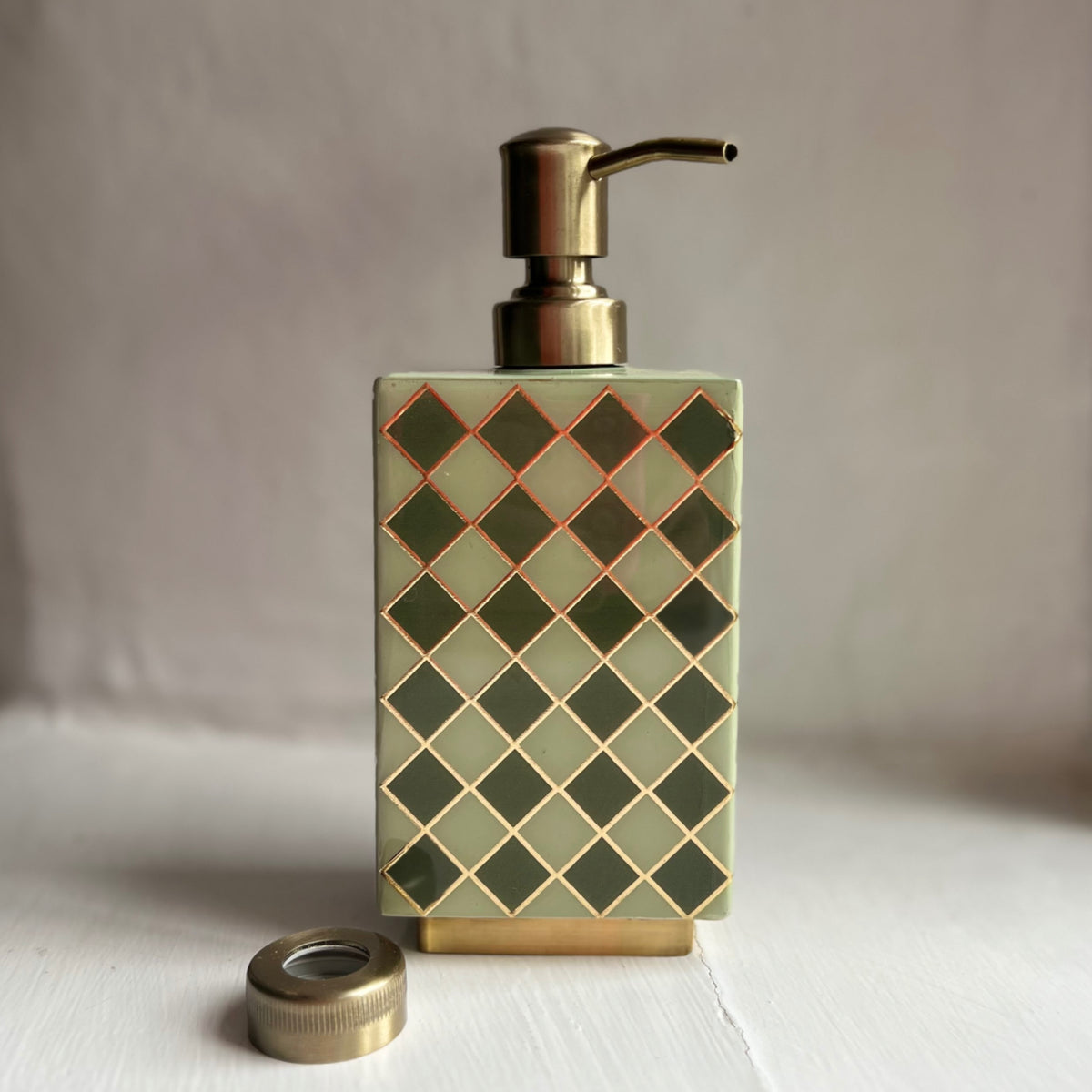 Harlequin enamel and brass multi-use bottle in Sage Green with its brass pump