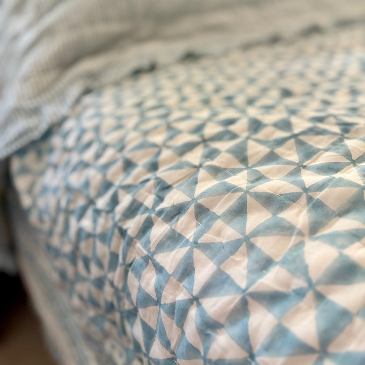 Harlequin reversible cotton quilt in Sea Breeze Blue, geometric print detail
