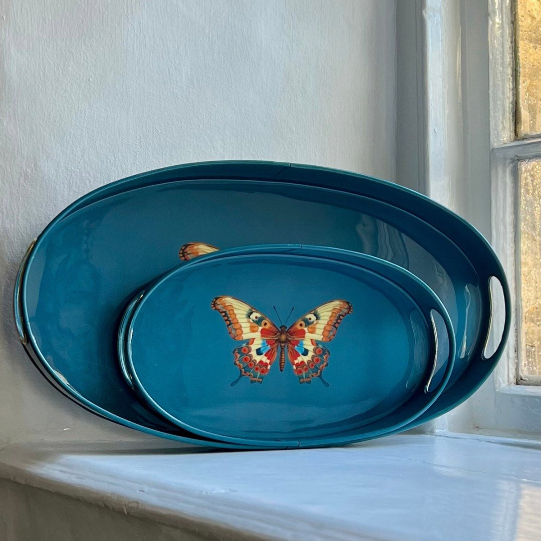 Butterfly small oval tray in teal enamel and brass beside the large size