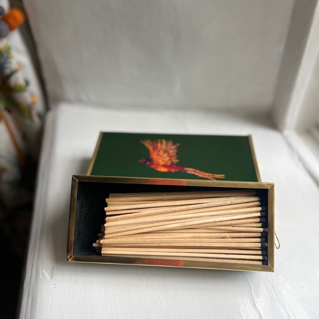 Extra-long safety matches inside an enamel oversized matchbox