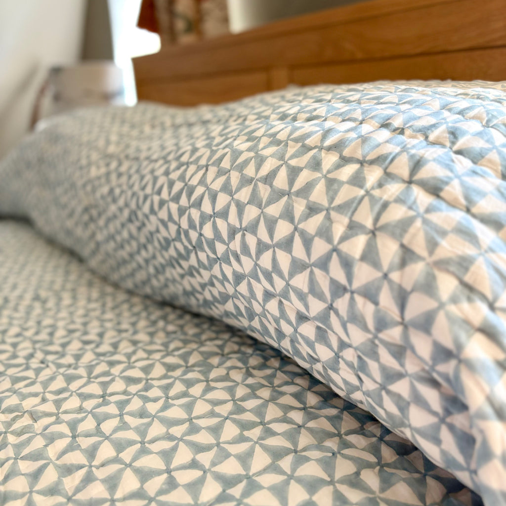 Harlequin reversible cotton quilt in Sea Breeze Blue, close-up of the hand block print
