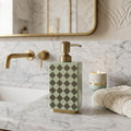 Harlequin enamel and brass multi-use bottle in Sage Green as a soap dispenser beside a basin