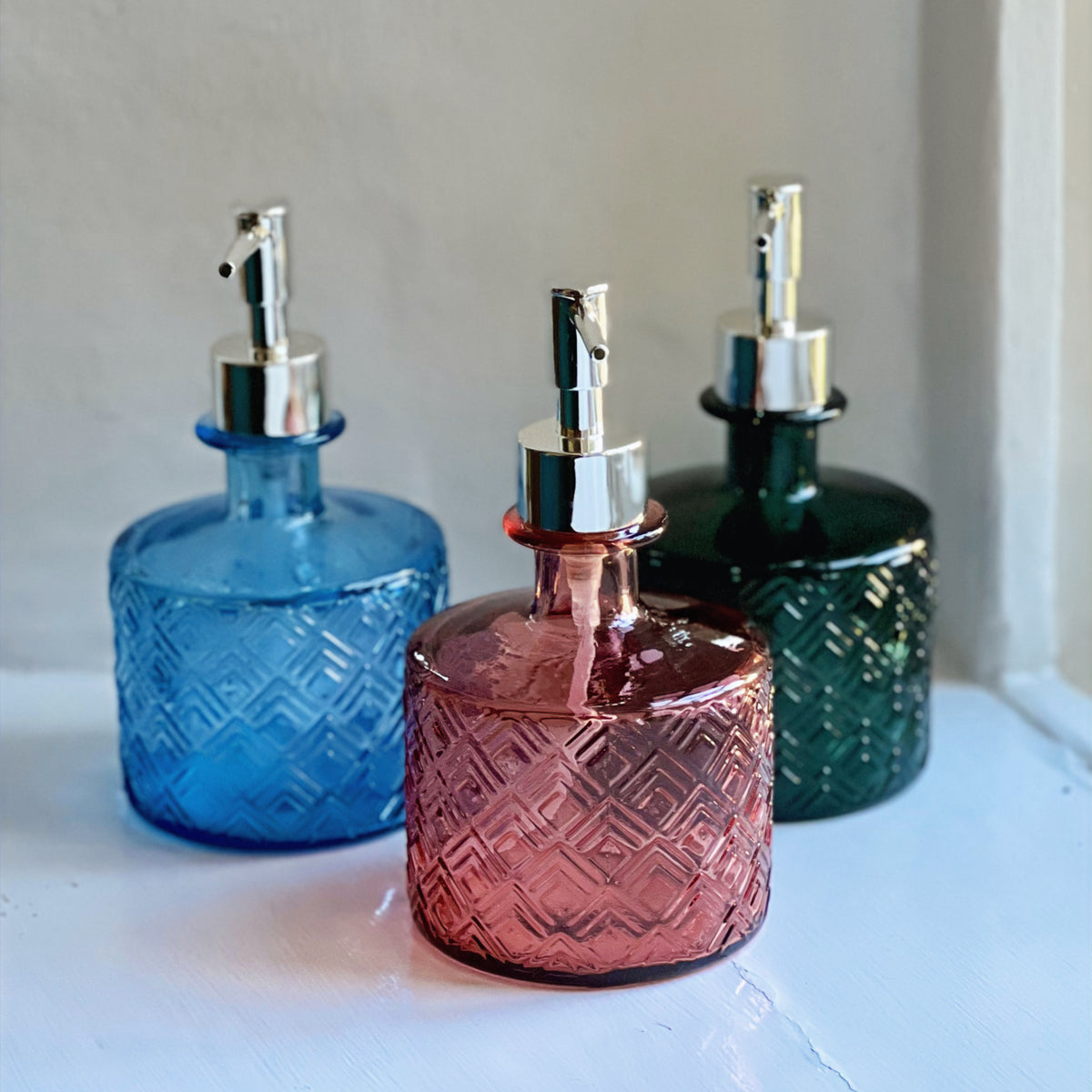 Recycled glass soap dispensers in blue, pink and green