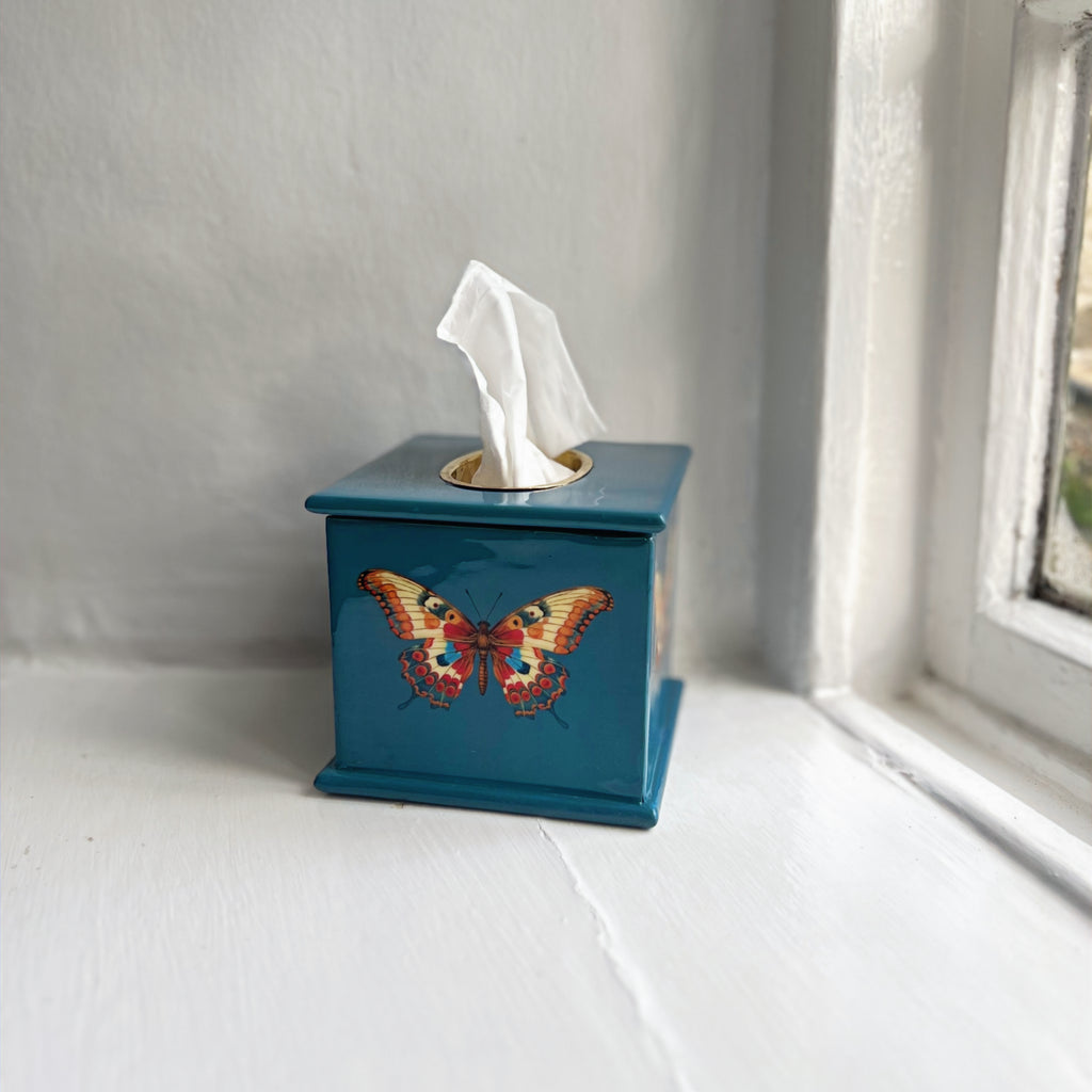Butterfly square tissue box in teal enamel and brass on a windowsill