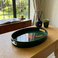 Pheasant large oval tray in bottle green enamel and brass on a sideboard