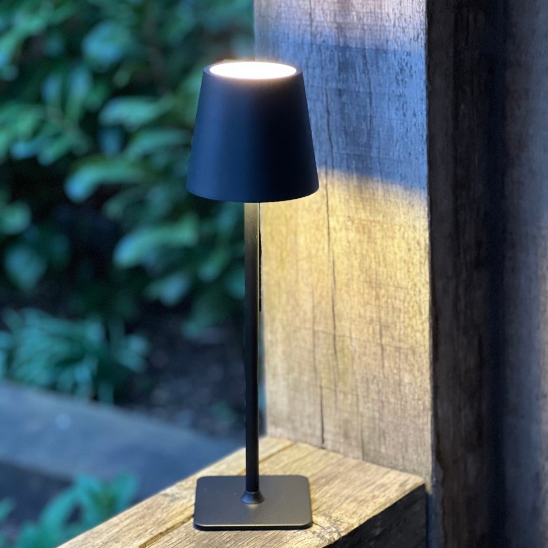 Black LED cordless lamp switched on outdoors