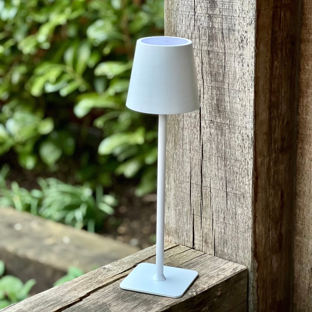 White LED cordless table lamp on a garden table