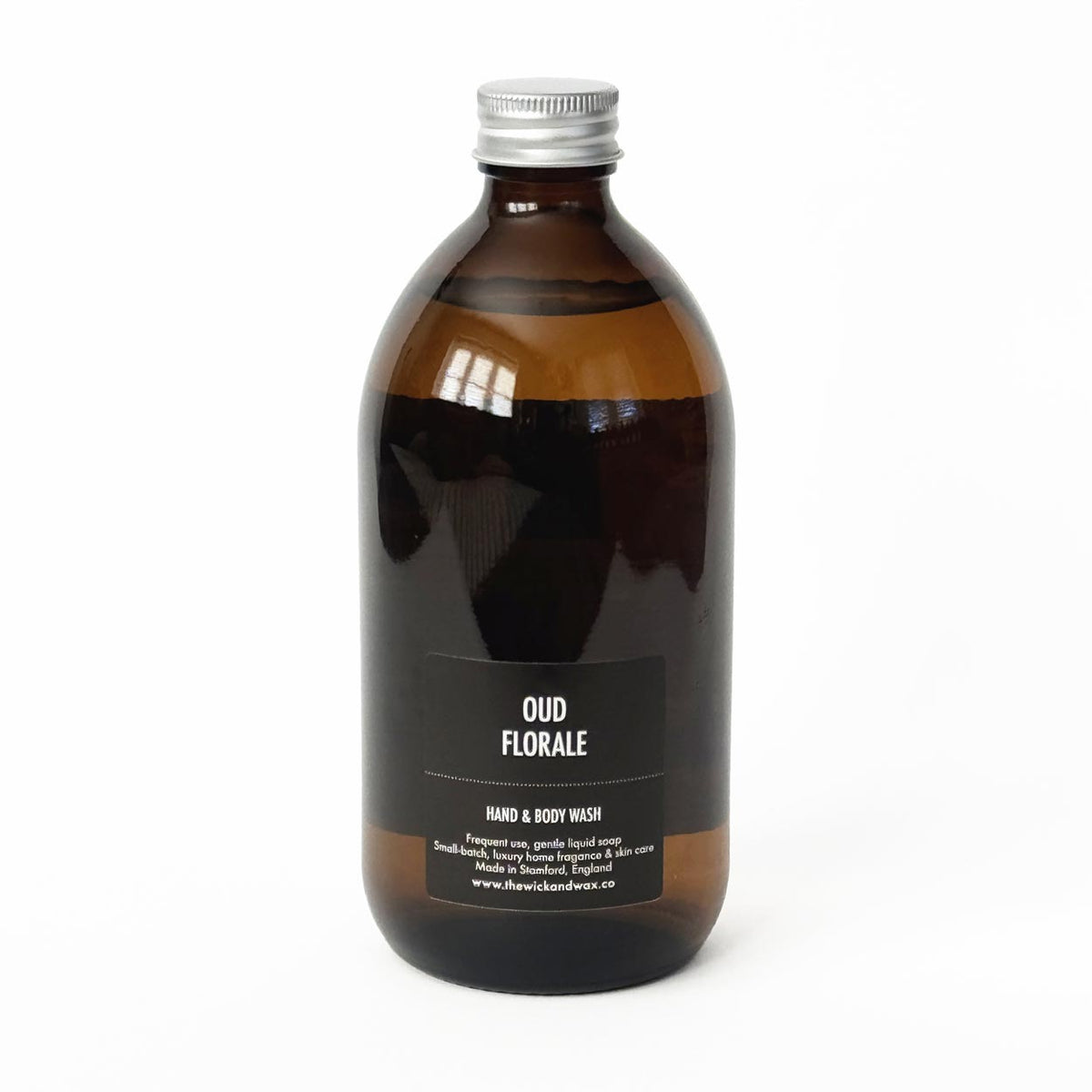 Amber glass bottle of The Wick and Wax Co hand and body wash
