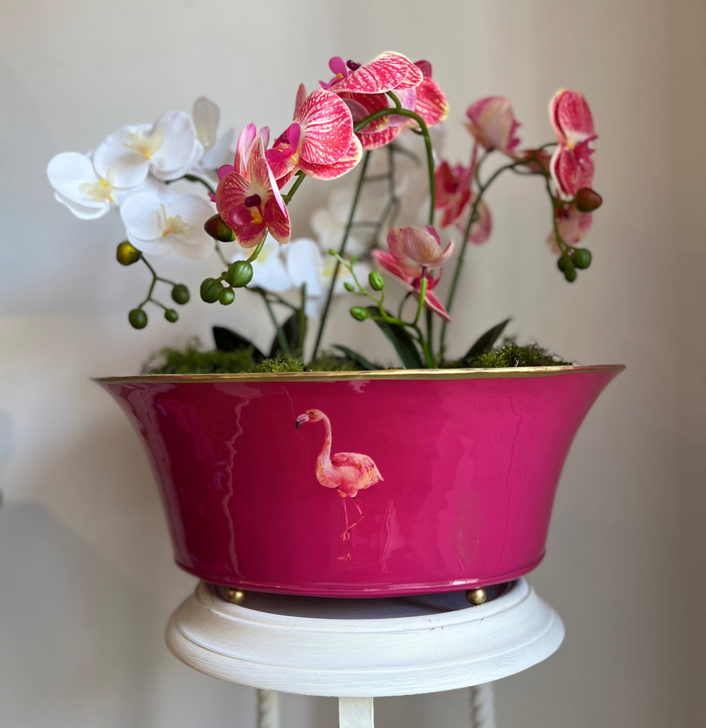 Raspberry pink Flamingo planter holding white and pink orchids