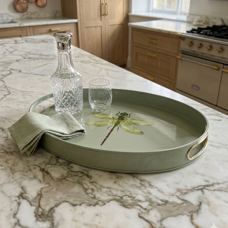 Dragonfly large oval tray in sage green enamel and brass with glasses on a kitchen worktop