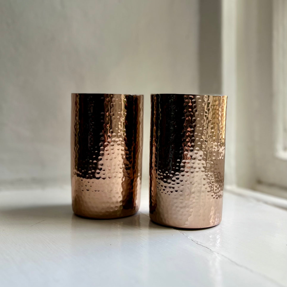 Pair of handmade hammered metal tumblers in rose gold