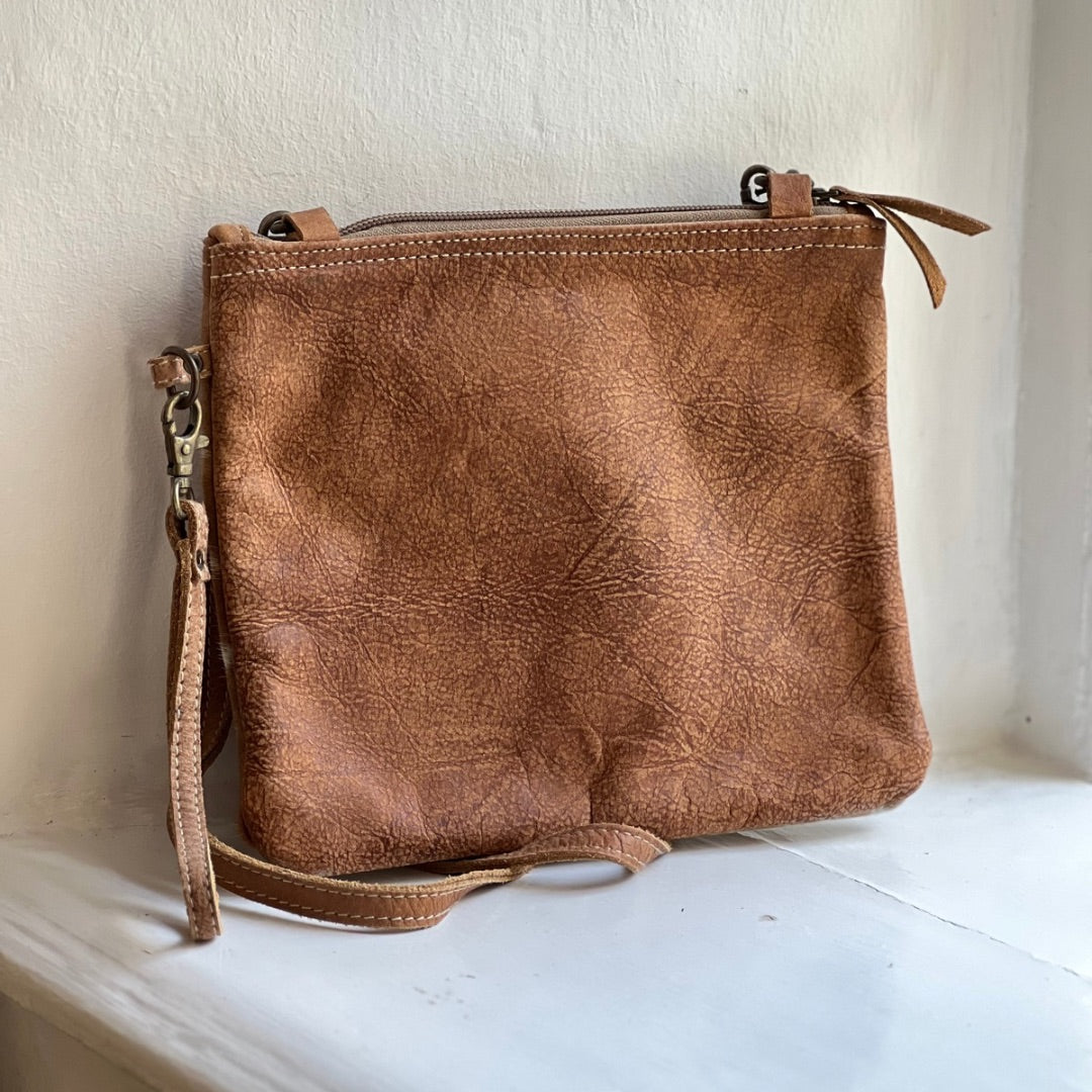 Back of the square crossbody bag in tan leather