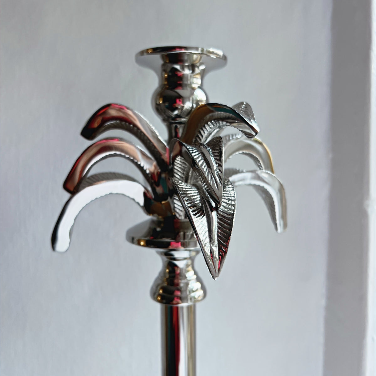 Close-up of the textured palm fronds on the large candlestick