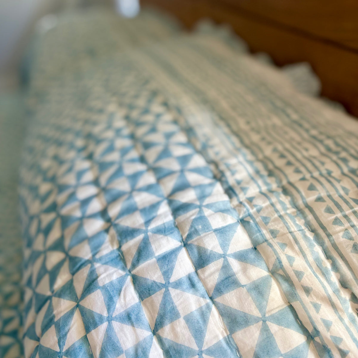 Harlequin reversible cotton quilt in Sea Breeze Blue, detail of the hand stitching