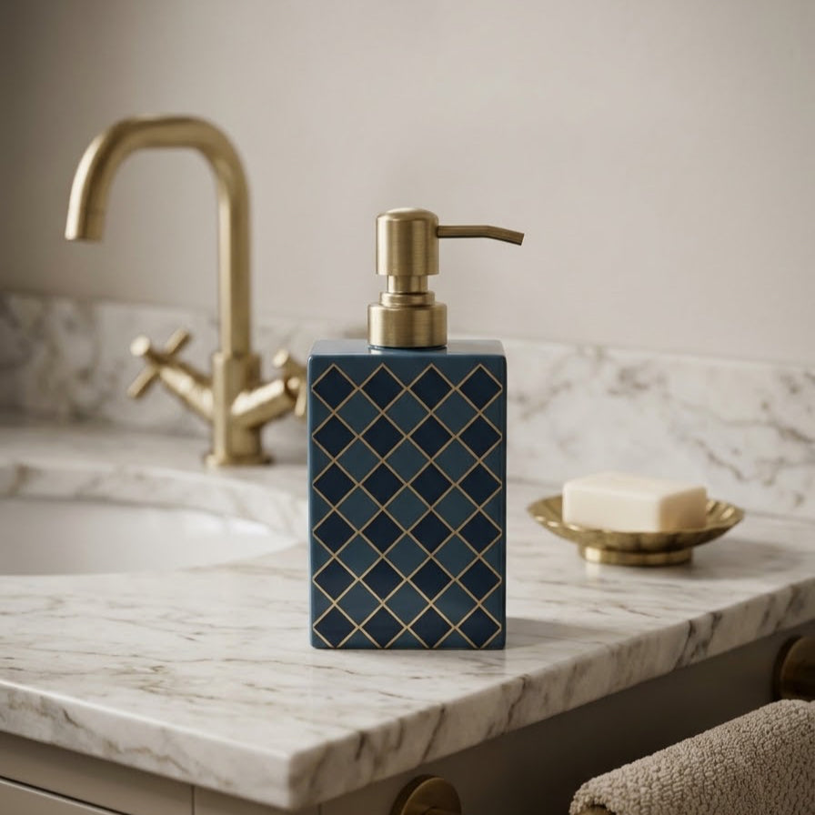 Harlequin enamel and brass multi-use bottle in Denim Blue beside a bathroom tap
