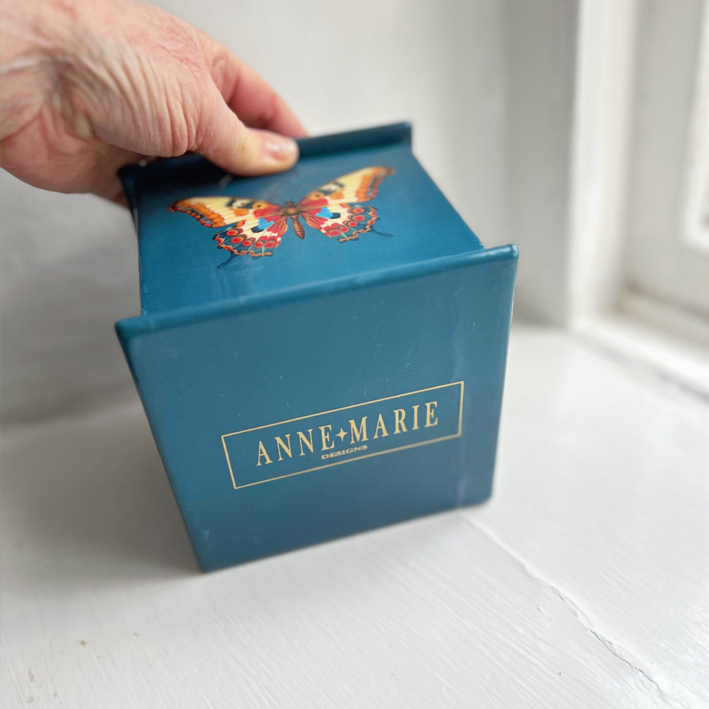 Butterfly square tissue box in teal enamel and brass with its lid lifted for refilling