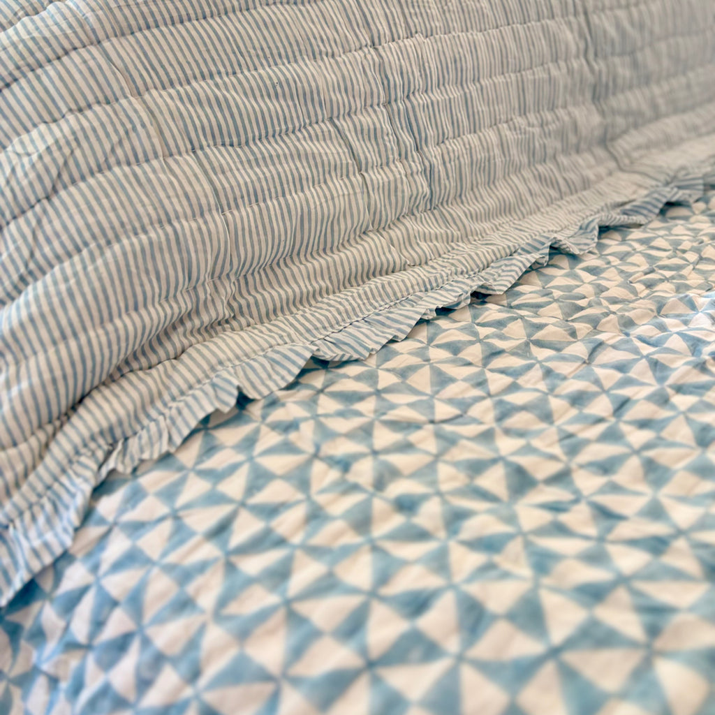 Harlequin reversible cotton quilt in Sea Breeze Blue showing the reverse side