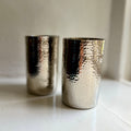 Pair of handmade hammered metal tumblers in silver