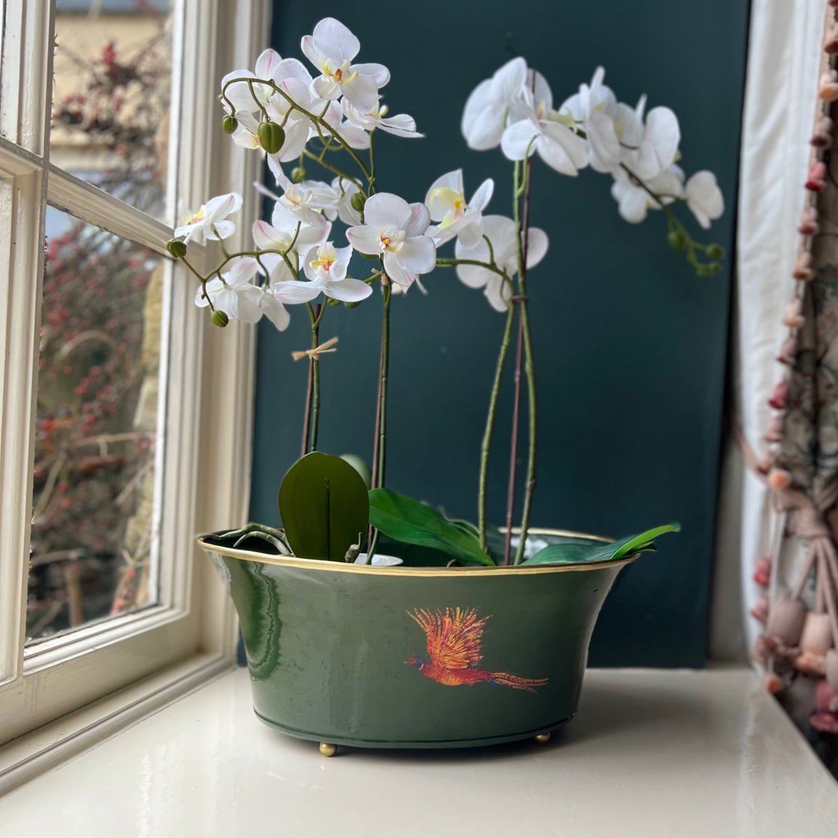Pheasant ornamental planter in green with white orchids