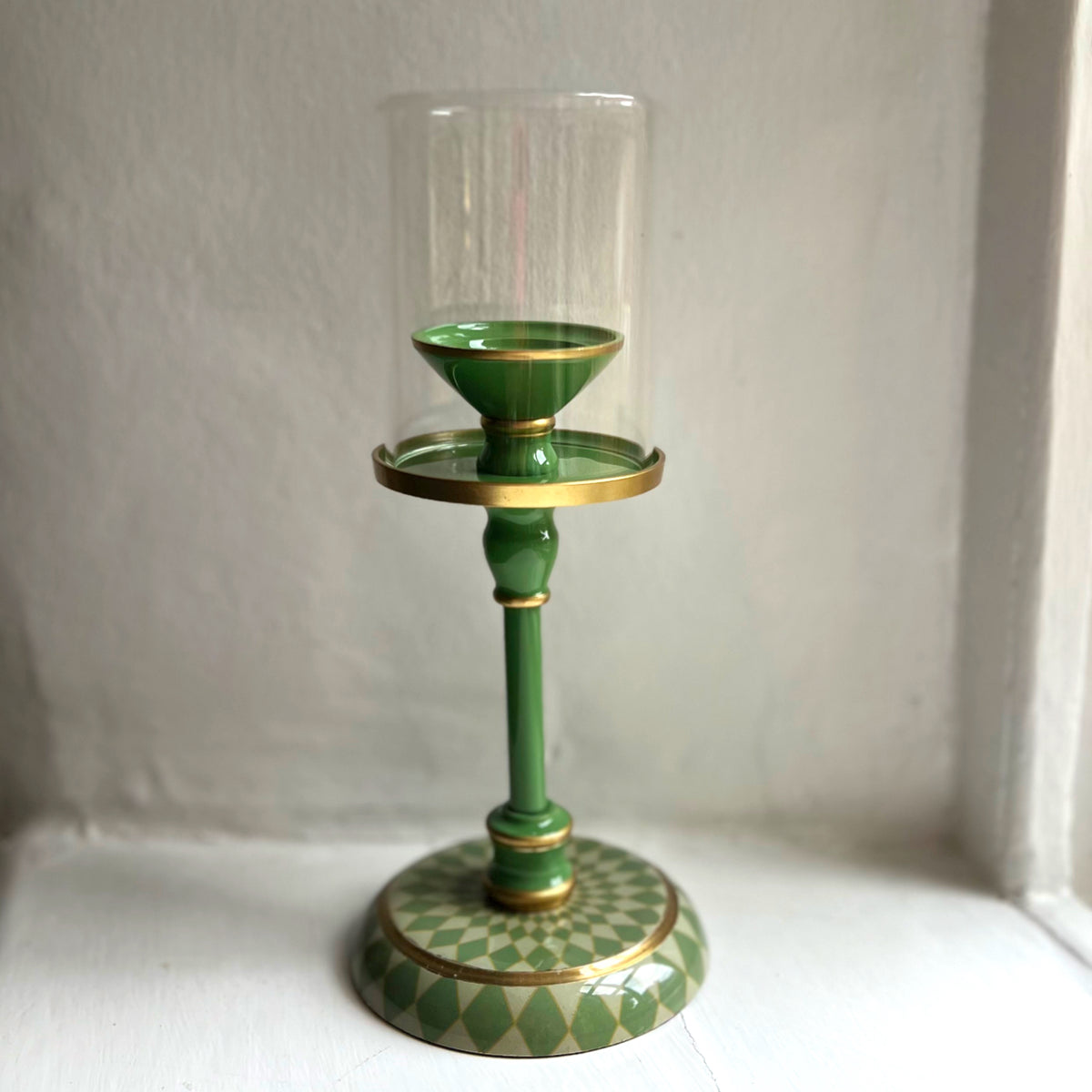 Harlequin hand-enamelled brass hurricane candle holder in Sage Green with a glass sleeve