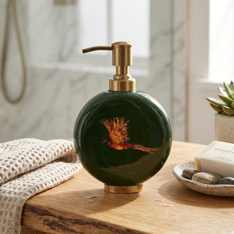 Pheasant enamel and brass soap dispenser in dark green on a bathroom shelf