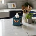 Butterfly square tissue box in teal enamel and brass on a kitchen worktop