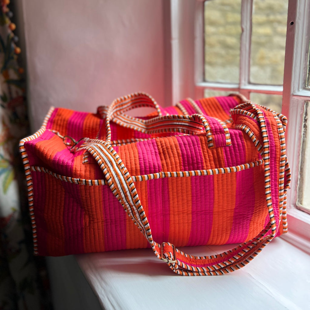 Harlequin quilted cotton weekend bag in orange and pink, side view