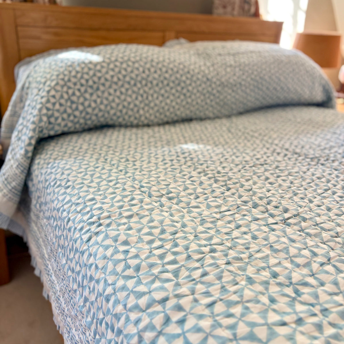 Harlequin reversible cotton quilt in Sea Breeze Blue with matching pillowcases