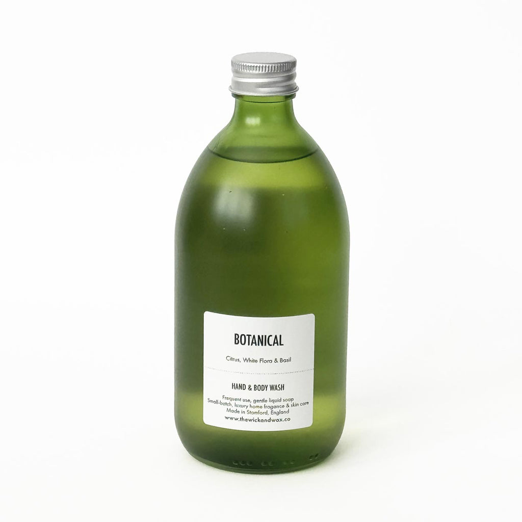 Green glass bottle of The Wick and Wax Co hand and body wash
